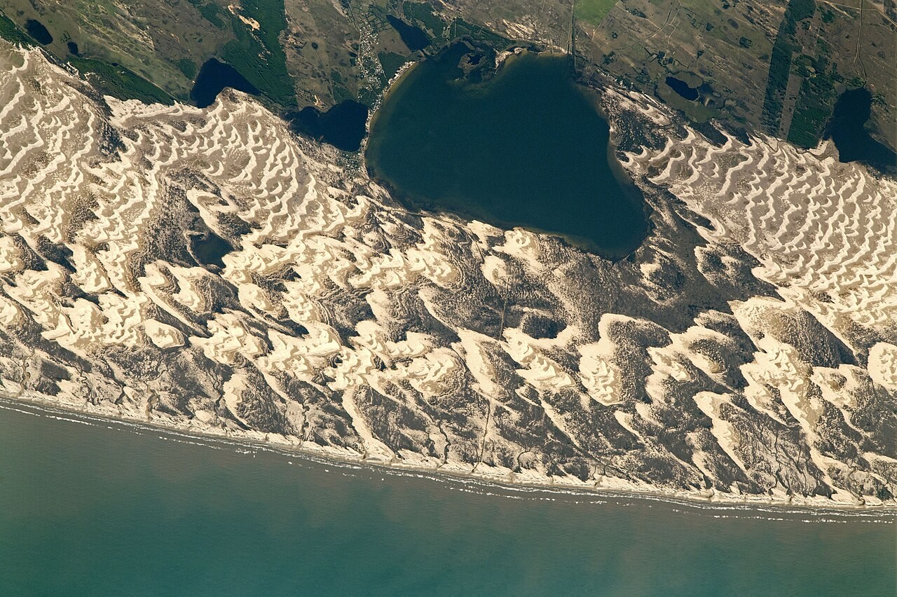 Crescent-shaped dunes around Lagoa dos Barros on Brazil's Atlantic coast, seen from the ISS.