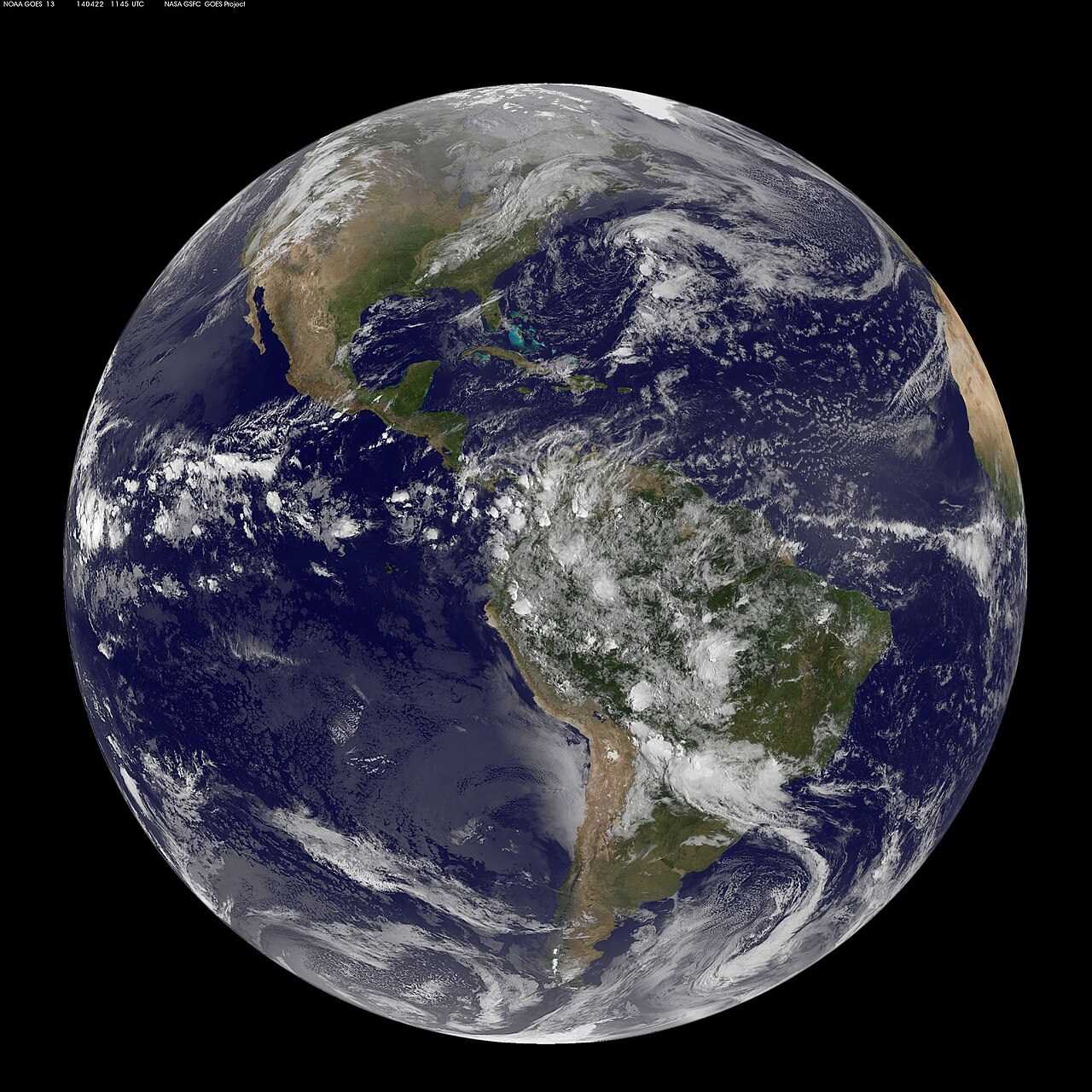 GOES-East satellite view of the Americas with tropical cloud bands and midlatitude weather systems.