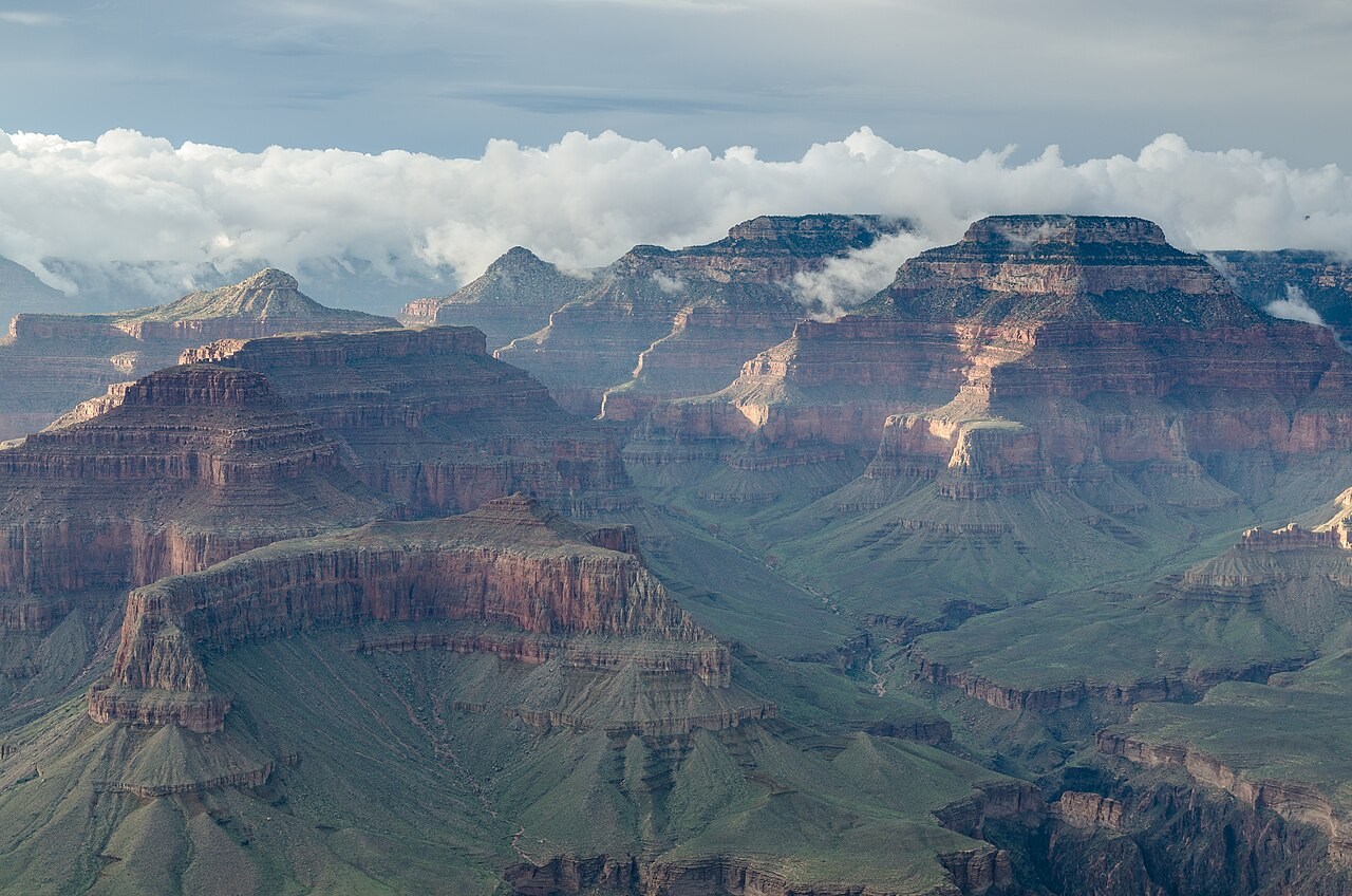 Layered cliffs, mesas and deeply incised valleys of the Grand Canyon in evening light.