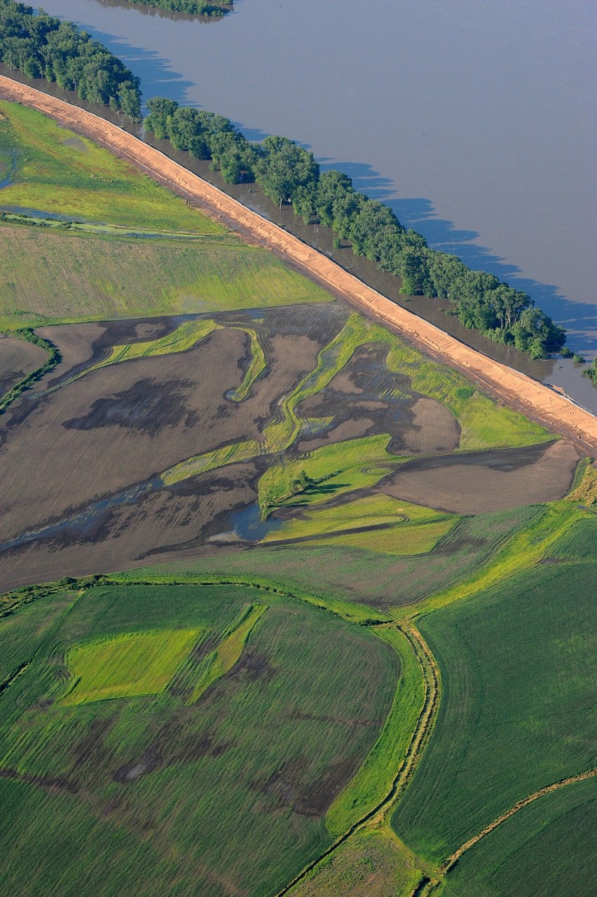 A raised embankment separates floodwater from farmland beside the Mississippi at Hannibal, Missouri.
