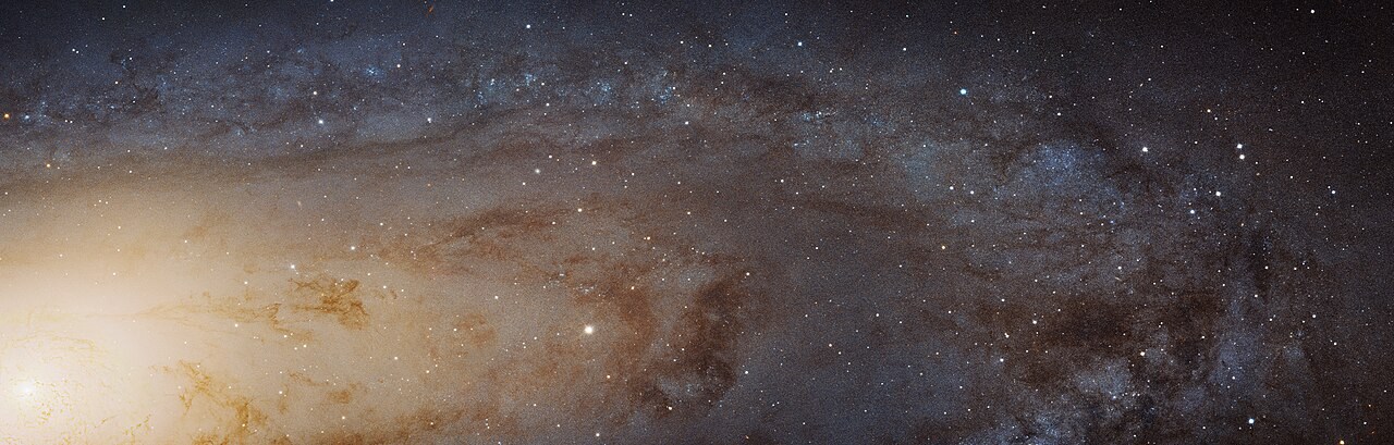 A Hubble mosaic of Andromeda's bright central region, dark dust lanes and densely packed stars.