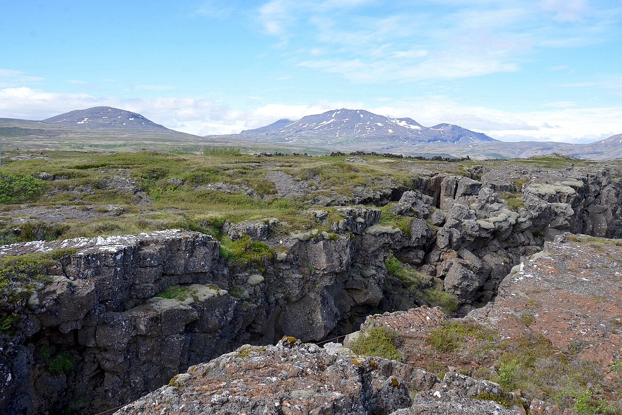Steep dark rock walls border the Almannagjá rift at Þingvellir, Iceland.